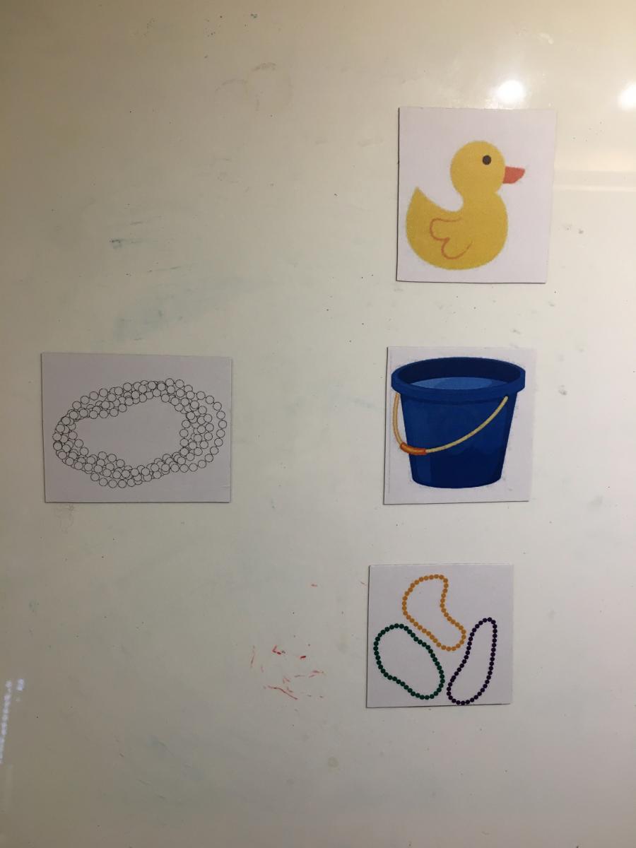 Picture cards of black & white drawing of necklace, yellow duck, blue bucket, and 3 beaded necklaces of different colors