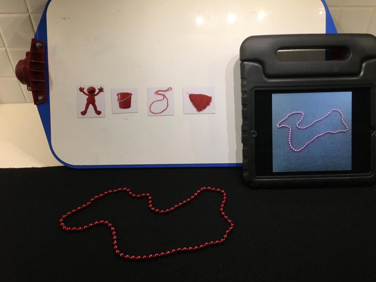 Shiny red beads with image on iPad and picture cards