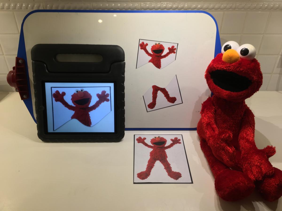 Stuffed Elmo with Elmo photo on tablet and Elmo puzzle