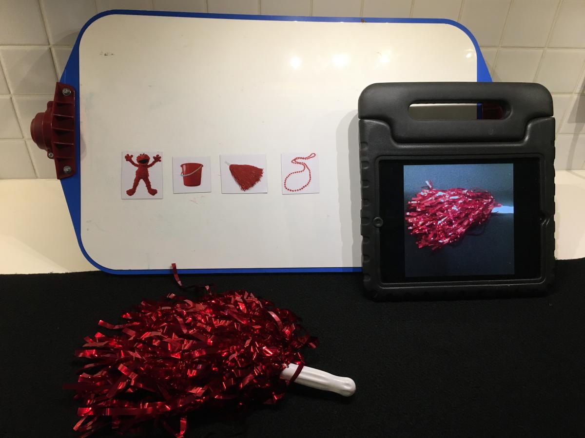 Matching red mylar pompom to iPad image and picture symbol card