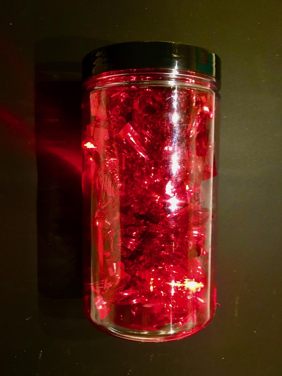 Red mylar garland in an empty plastic container