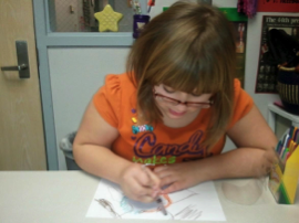 girl drawing with glasses on