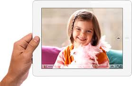 hand holding iPad with a picture of a little girl