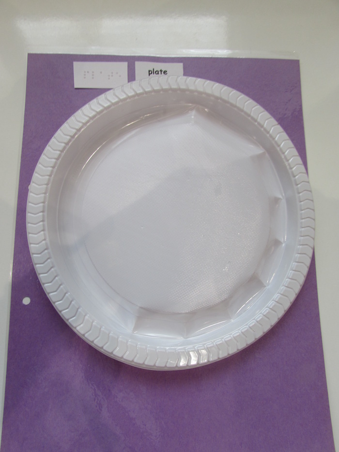 tactile plastic plate on purple paper