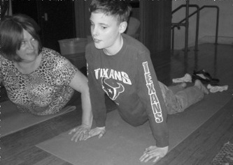 Linda and her student doing the cobra pose Linda and a student do a yoga pose