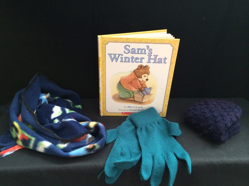 Sam's winter hat book and a blanket gloves and a hat