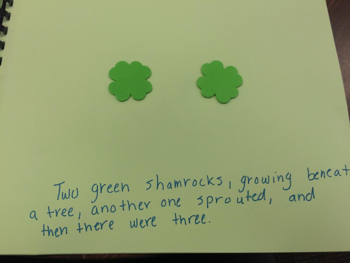 Two green shamrocks, growing beneath a tree, another one sprouted and then there were three.