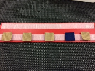 Track with four tan squares and one blue
