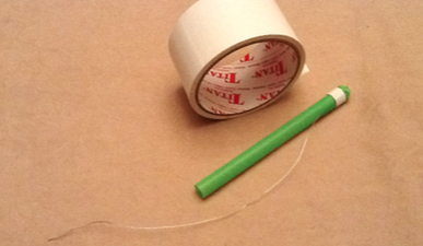 tape with a straw and wire attached to the top of the straw