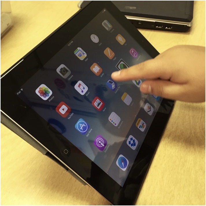student's finger swiping on iPad home screen