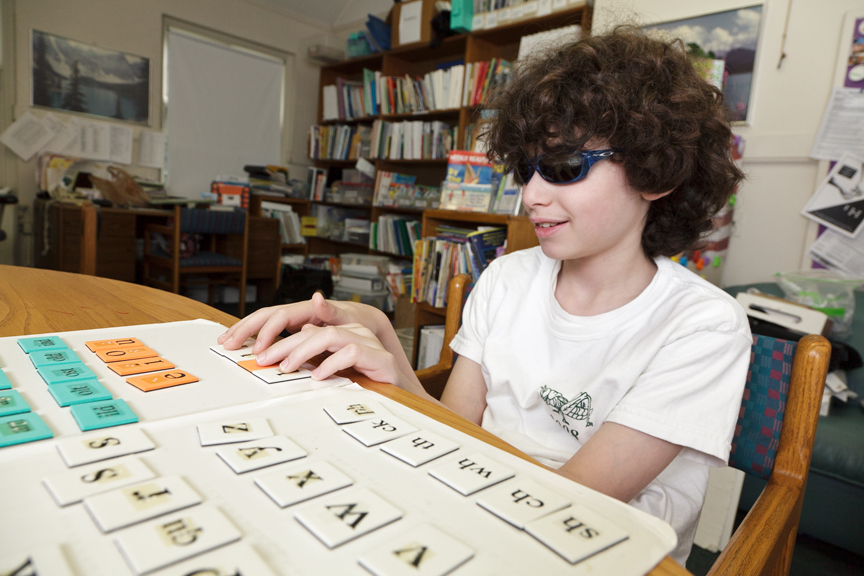 Student is using WRS magnetic braille tiles during spelling work (parts six through eight of the 10-step lesson plan) Student doing Wilson Reading System lesson in braille