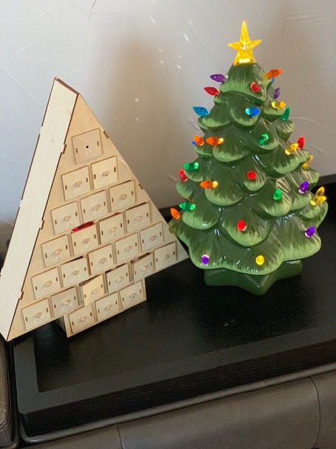 Advent calendar and ceramic Christmas tree on a table