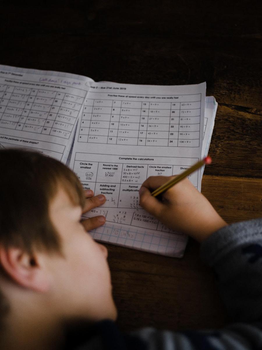 Boy writing in a test booklet