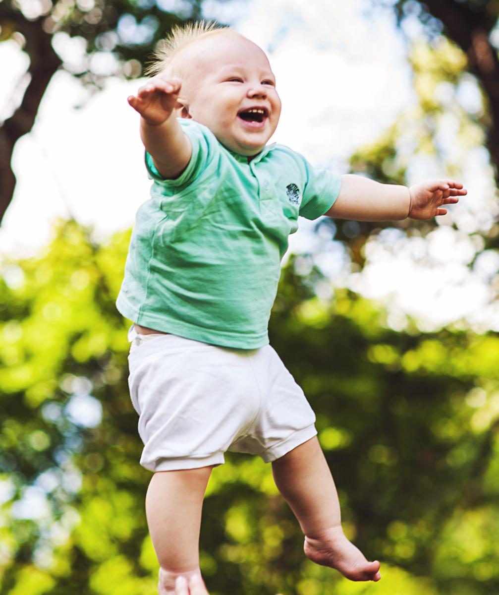 Happy baby up in the air
