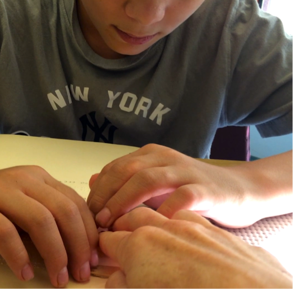 student touching hands