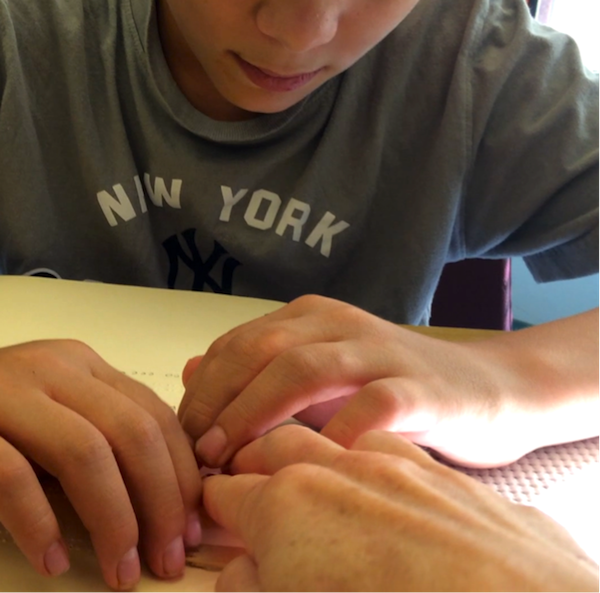 Click to view student touching hands