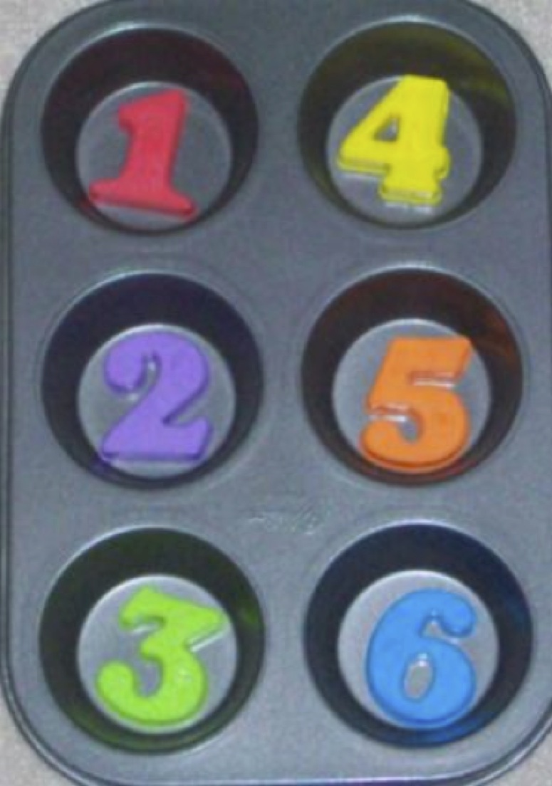 muffin tin with colored numbers in it