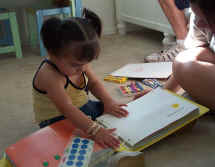 Toddler exploring braille book