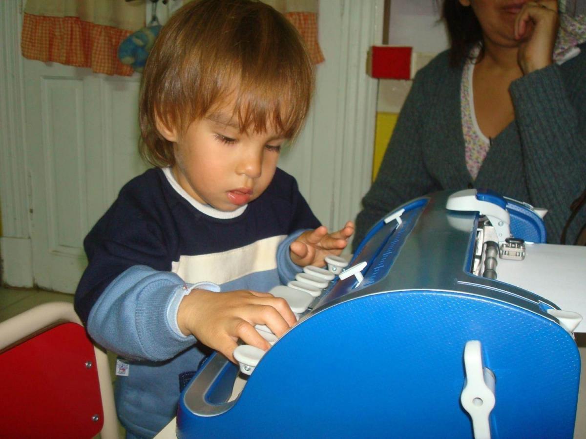 Boy with braille writer