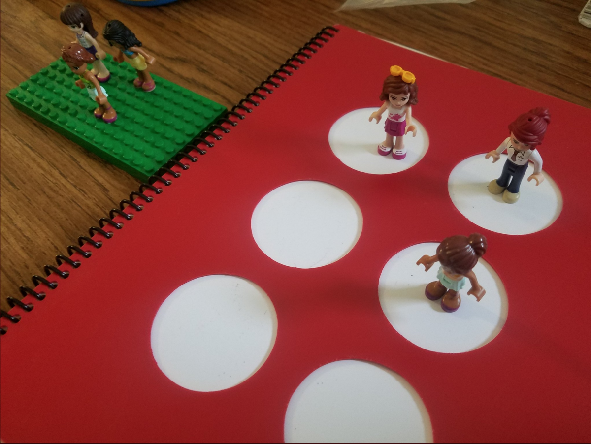 Practicing the letter “d” with the Lego Girls.  The braille cell template is from APH’s Lots of Dots book.  A single Lego girl is placed in the corresponding braille cell on the template and on the Lego base.