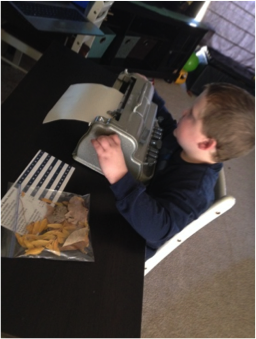 Boy using braille writer