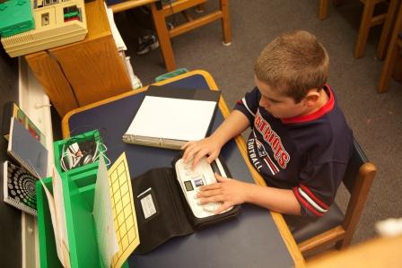 Boy using his braille notetaker