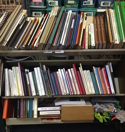tactile books on bottom shelf of media center