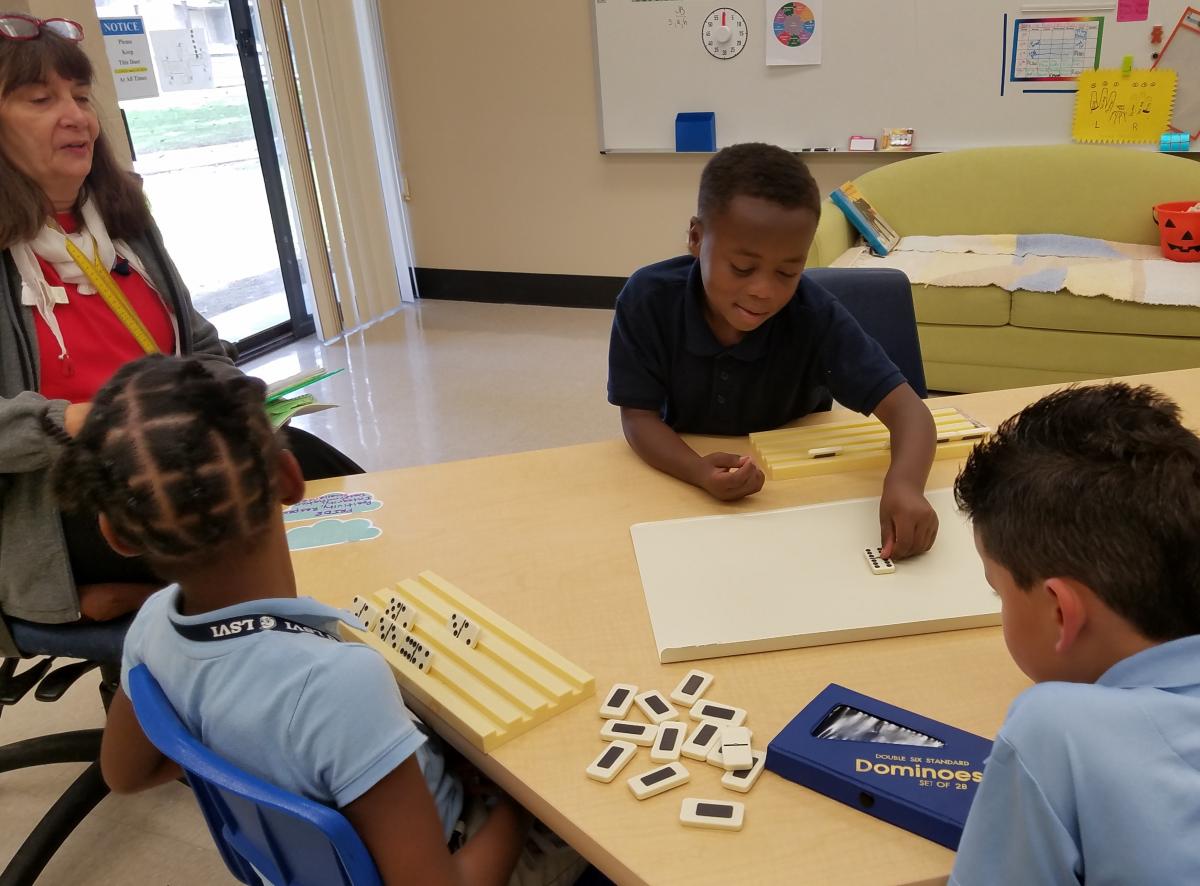 Students playing dominoes