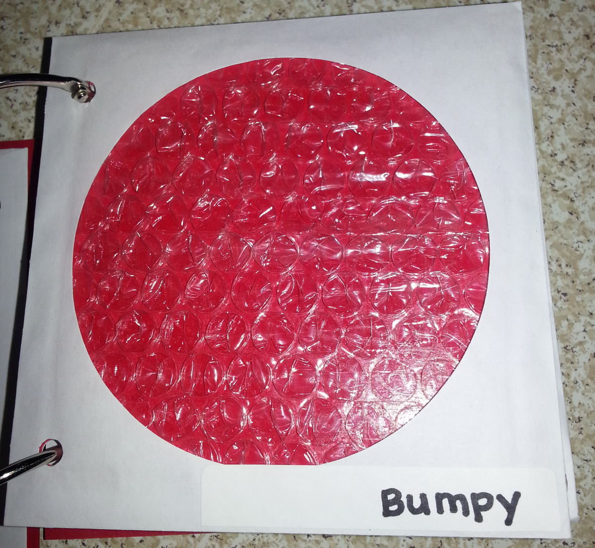 bumpy texture page with red circle and bubble wrap