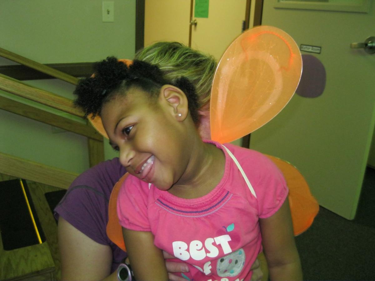 Young girl wears butterfly wings