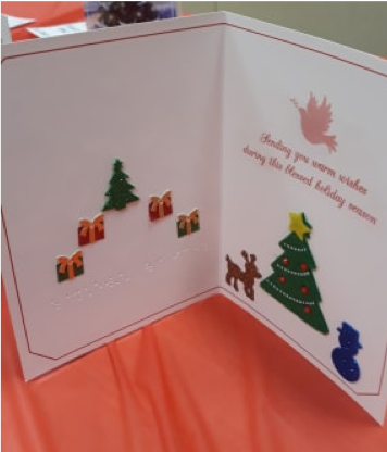 Inside of holiday card with braille and tactile stickers