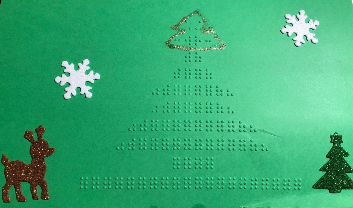 Green holiday card with braille Christmas tree and tactile stickers of snowflakes and reindeer
