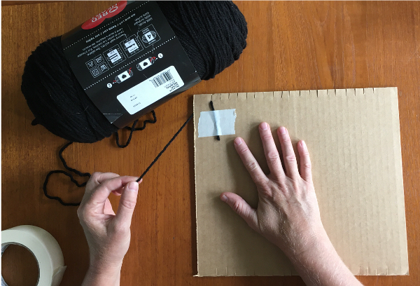 Put on the warp yarn by taping it to the back of the loom first