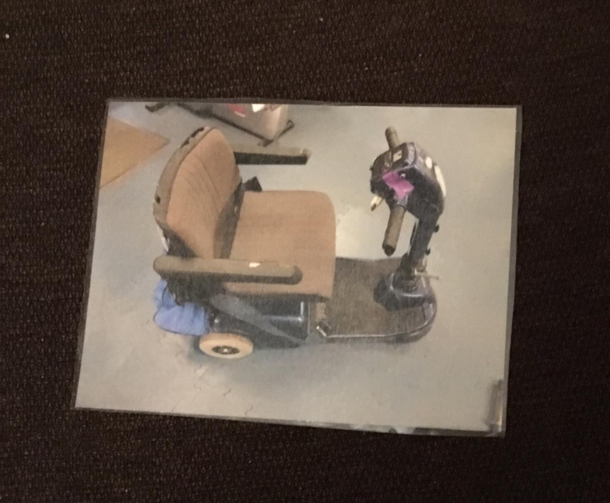 card with a photo of an electric wheelchair on it