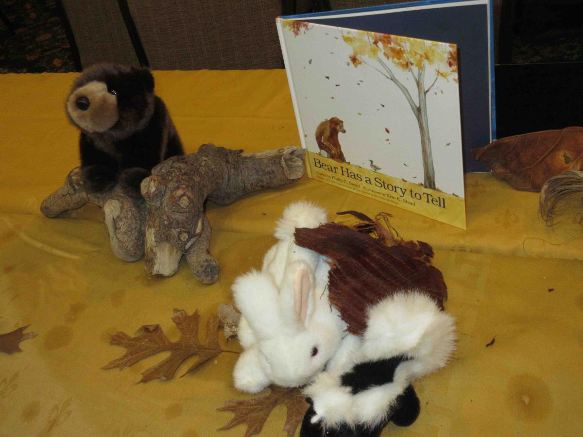Small stuffed bear, rabbit and skunk, with a real log Stuffed animals and log