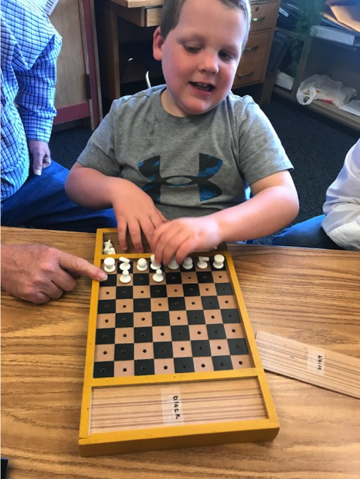Boy playing accessible chess