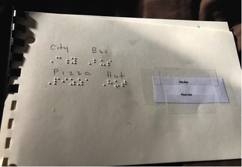 Book with City Bus and Pizza Hut in braille