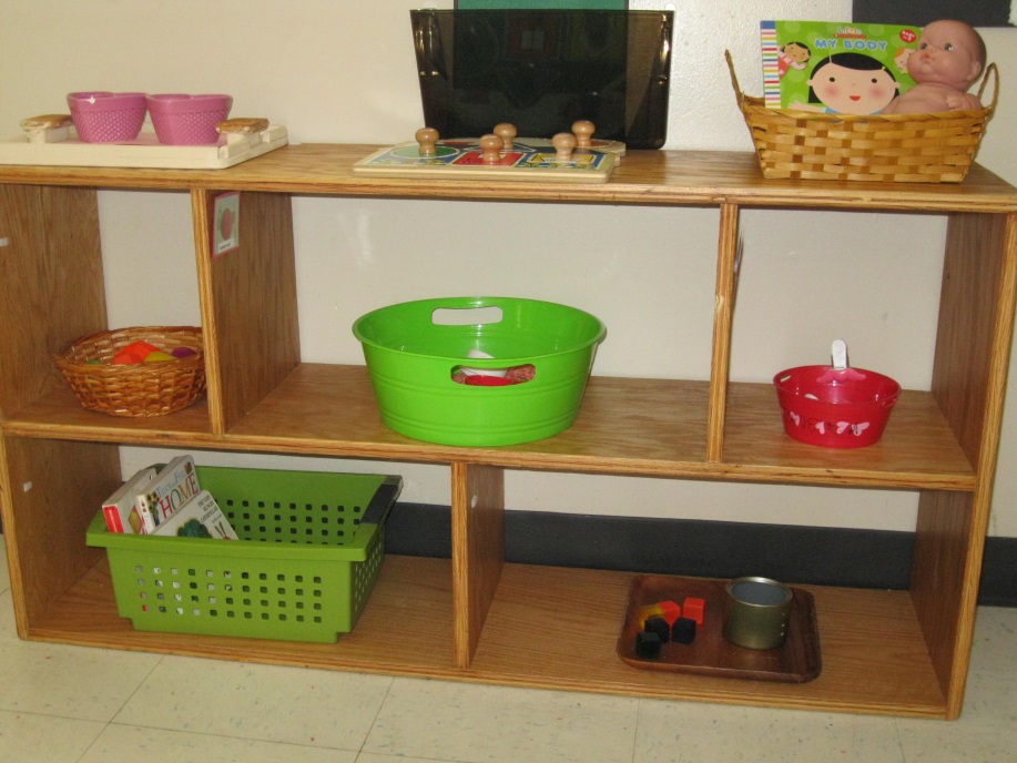 A shelf set up in my classroom. You can see that it is not cluttered, everything is spaced out and the children can manage all the separate activities and clearly see or figure out what goes together. Classroom shelves