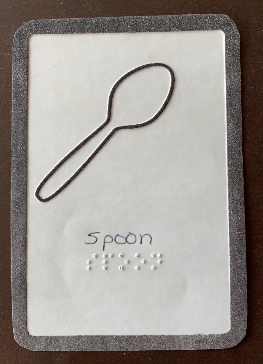 Flashcard of spoon with braille label and tactile image