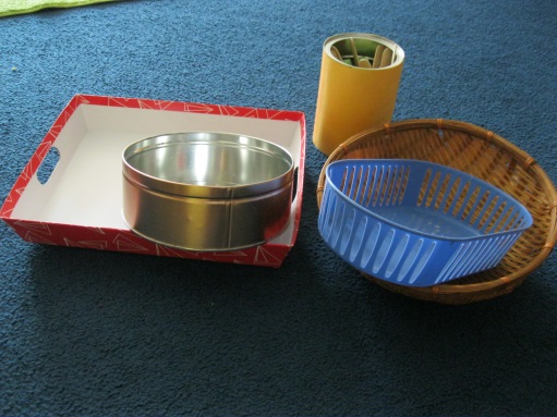 Look around your home to find baskets, old coffee cans… look at the dollar store for cookie trays, or small plastic containers. I also LOVE Goodwill for baskets!! Handles are helpful for carrying things that require balance (some kids need the reminder of where to hold, but many kids figure it out quickly without a handle. containers for organizing work