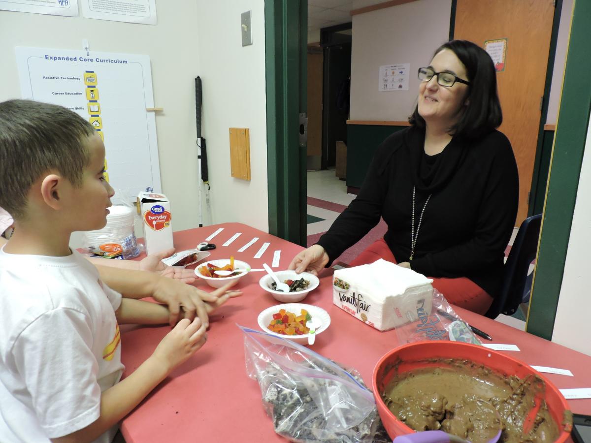 A boy prepares food for the staff