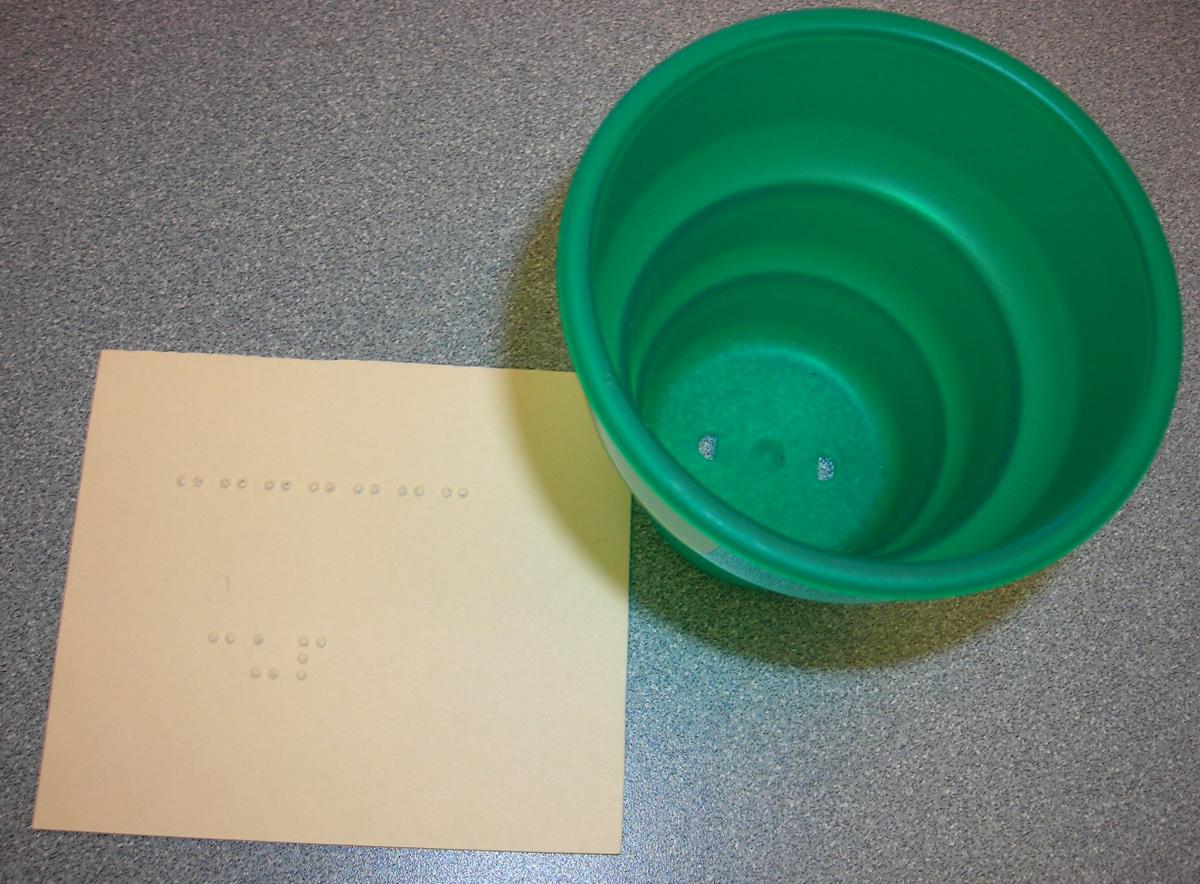 Photo of cup with braille word card