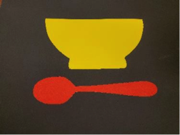 Red spoon under yellow bowl