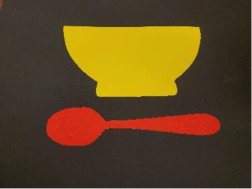 Red spoon under yellow bowl Red spoon under yellow bowl