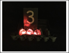 Three red lighted eggs with the number 3
