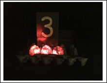 Three red lighted eggs with the number 3