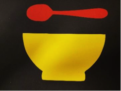 Red spoon over yellow bowl