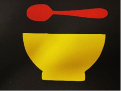 Red spoon over yellow bowl Red spoon over yellow bowl