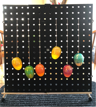 Easter eggs on black pegboard