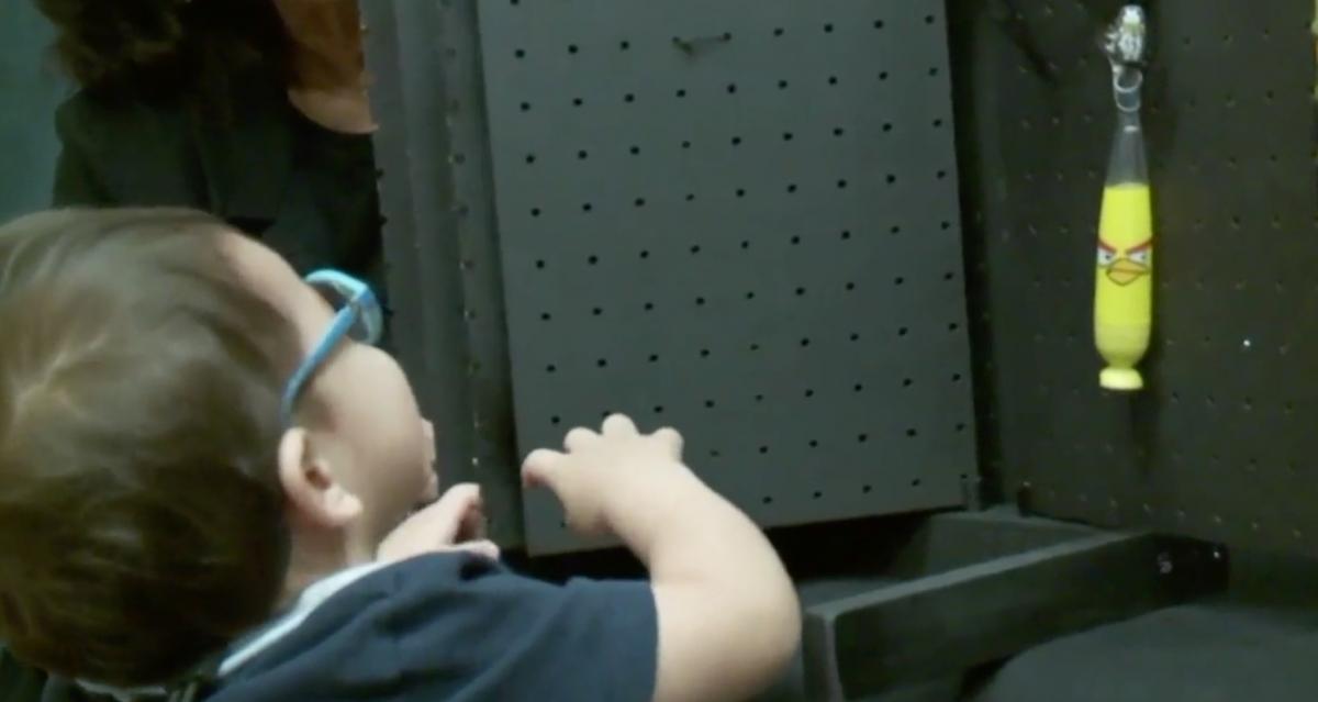 Video of child examining pegboard book